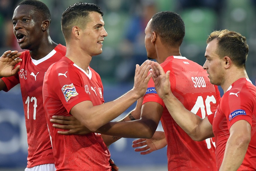 Switzerland&#039;s Denis Zakaria, left, Granit Xhaka, Center and Xherdan Shaqiri, right, celebrates after the sixt goal for Switzerland during the UEFA Nations League group stage match between Switzer ...