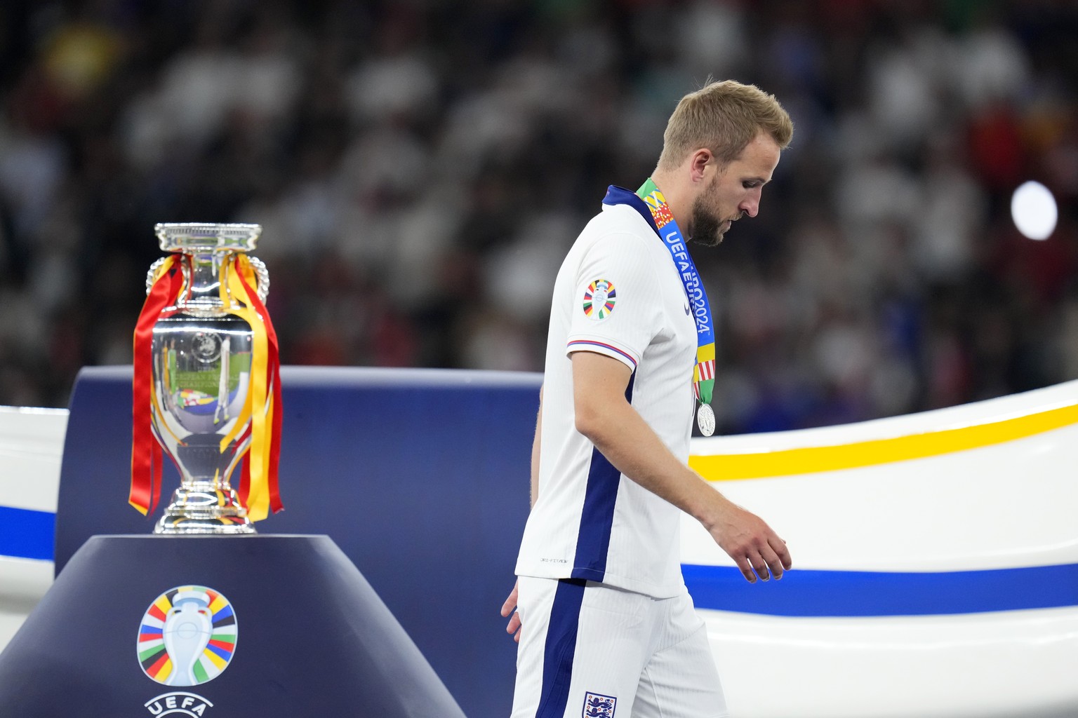 England&#039;s Harry Kane walks past the trophy after the final match between Spain and England at the Euro 2024 soccer tournament in Berlin, Germany, Sunday, July 14, 2024. Spain won 2-1. (AP Photo/M ...
