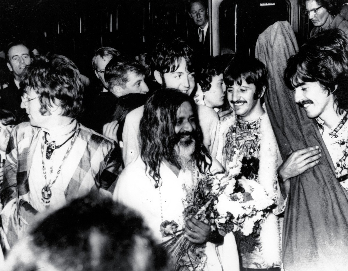 The Beatles join the Maharishi Mahesh Yogi, center, as they arrive by train at Bangor, Wales, to participate in a weekend of meditation, in this August 26, 1967, file photo. From left to right are, Jo ...