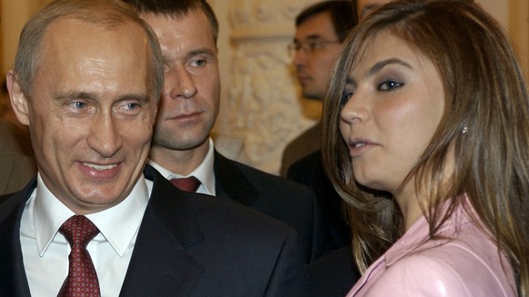 FILE - In this Thursday, Nov. 4, 2004 file photo President Vladimir Putin, left, speaks with gymnast Alina Kabaeva at a Kremlin banquet in Moscow, Russia. Alina Kabayeva, the Olympic gold gymnast whos ...