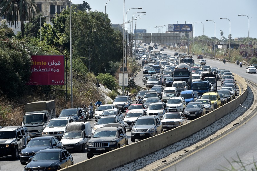 epa11622227 Lebanese people, who are fleeing southern Lebanon, travel on their cars along the Damour highway towards Beirut, Lebanon, 24 September 2024. Thousands of people fled southern Lebanon after ...