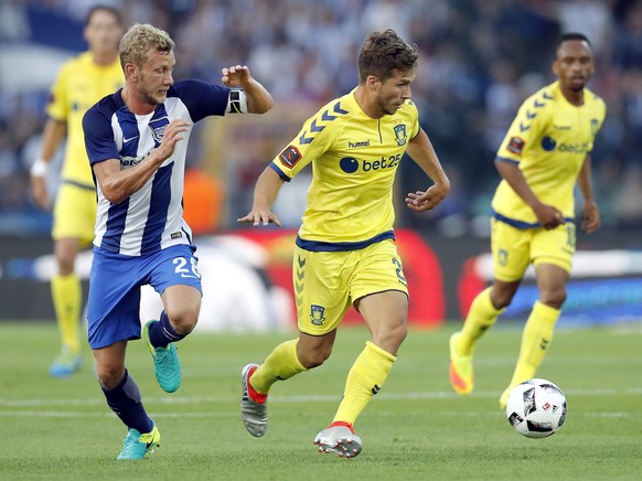 Berlin's Fabian Lustenberger, left, and Brondby's Andrew Hjulsager, right, challenge for the ball during the Europe League third qualifying round first leg soccer match between Hertha BSC and Brondby  ...
