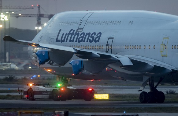 FILE - In this Thursday, Oct. 22, 2020, file photo, a Lufthansa Boeing 747 with covered engines is pulled to a parking position at the airport in Frankfurt, Germany. GermanyÄôs biggest airline, which ...