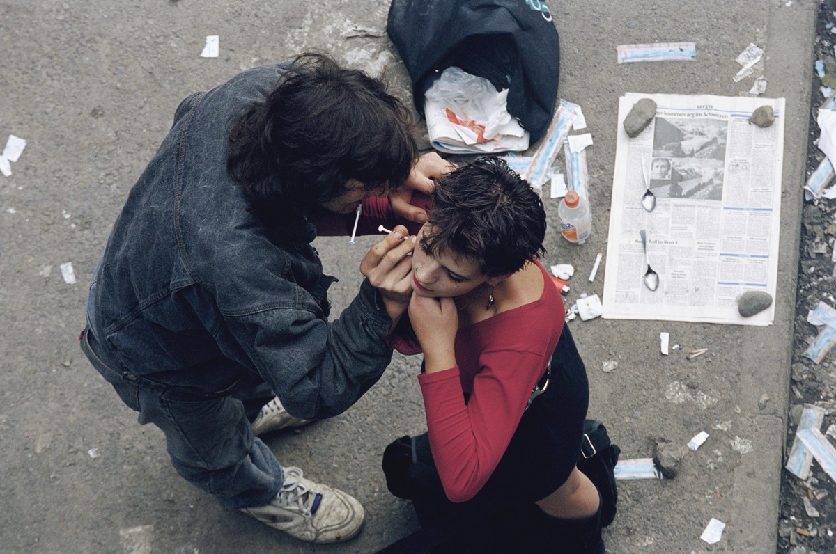 A young woman has a shot of heroin injected into her neck at Letten Station, an abandoned railroad station in Zurich, Switzerland, where the city's new liberal drug policy allows drug users to ga ...