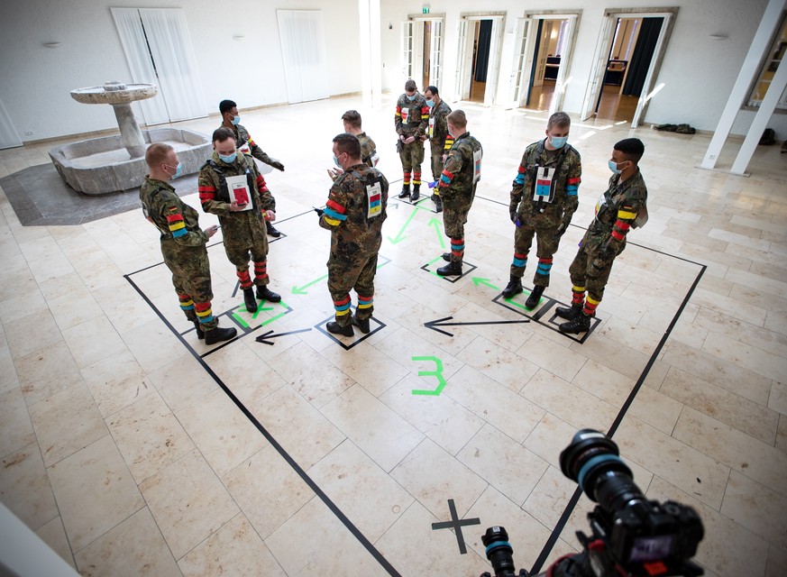 epa08369280 A handout photo made available by German Armed Forces Bundeswehr shows soldiers during a test of a smart phone app using Pan-European Privacy-Preserving Proximity Tracing (PEPP-PT) at the  ...