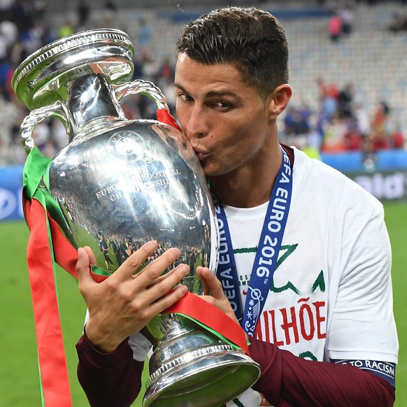 ARCHIV - ZUM RUECKBLICK AUF DIE EM 2016 STELLEN WIR IHNEN FOLGENDES BILDMATERIAL ZUR VERFUEGUNG - epa05419742 Cristiano Ronaldo of Portugal kisses the trophy after winning the UEFA EURO 2016 Final mat ...