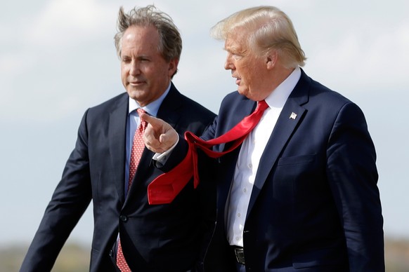 FILE - President Donald Trump walks with Texas Attorney General Ken Paxton, left, at Austin-Bergstrom International Airport in Austin, on Wednesday, Nov. 20, 2019. (AP Photo/Evan Vucci, File)
Donald T ...