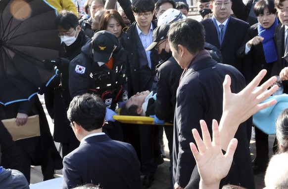 South Korean opposition leader Lee Jae-myung on a stretcher, is carried by rescue team in Busan, South Korea, Tuesday, Jan. 2, 2024. Lee was attacked and injured by an unidentified man during a visit  ...