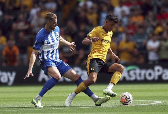 Brighton&#039;s Adam Webster, left and Wolverhampton Wanderers&#039; Matheus Nunes vie for the ball during the English Premier League soccer match between Wolverhampton Wanderers and Brighton &amp; Ho ...