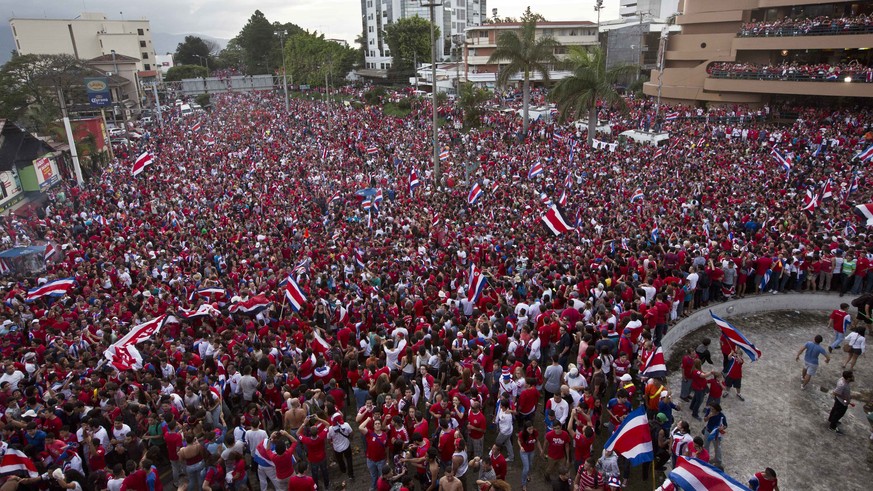 Costa Rica soccer fans fill the street as they celebrate their team's victory over Greece at a Brazil World Cup round of 16 game in San Jose, Costa Rica, Sunday, June 29, 2014. Costa Rica won a penalt ...