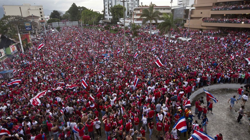 Costa Rica soccer fans fill the street as they celebrate their team&#039;s victory over Greece at a Brazil World Cup round of 16 game in San Jose, Costa Rica, Sunday, June 29, 2014. Costa Rica won a p ...