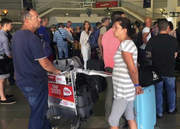British and Dutch tourists check in at Banjul Airport, Gambia, Wednesday Jan. 18, 2017. Special flights were being organized Wednesday to evacuate British and other tourists from Gambia, where the thr ...