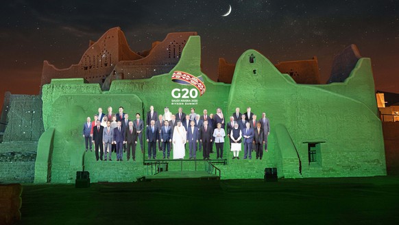 epa08831516 A handout photo made available by G20 Riyadh Summit shows a virtual family photo of G20 leaders projected on the walls of At-Turaif District in Ad-Diriyah, Riyadh, Saudi Arabia (issued 20  ...