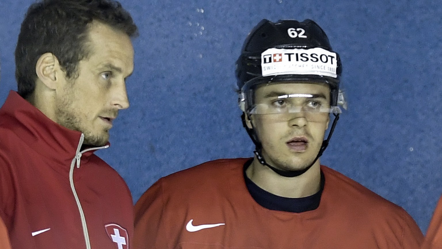 Patrick Fischer, head coach of Switzerland national ice hockey team, center, speak with the players Ramon Untersander, left, and Denis Malgin during a training session during the Ice Hockey World Cham ...