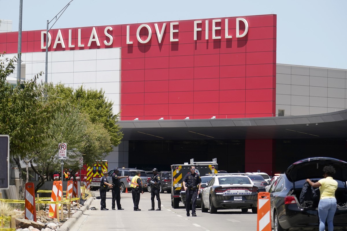 Emergency responders converge near the main entrance at Dallas Love Field in Dallas, Monday, July 25, 2022. A 37-year-old woman fired several gunshots, apparently at the ceiling, inside of Dallas' ...