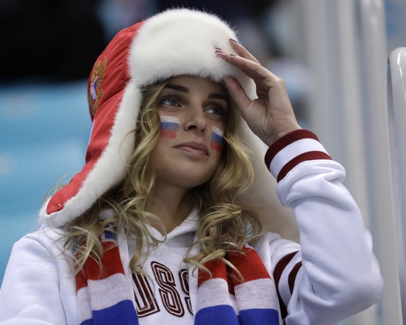 A fan of Olympic Athletes from Russia gets ready before the semifinal round of the men's hockey game between the team from Russia and the Czech Republic at the 2018 Winter Olympics in Gangneung, South Korea, Friday, Feb. 23, 2018. (AP Photo/Matt Slocum)