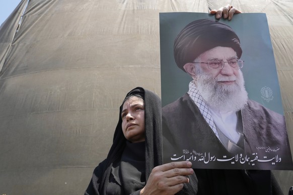 An Iranian protester holds up a poster of the Supreme Leader Ayatollah Ali Khamenei in an anti-Israeli gathering in Tehran, Iran, Friday, June 13, 2025. (AP Photo/Vahid Salemi)
APTOPIX Iran Israel Mid ...