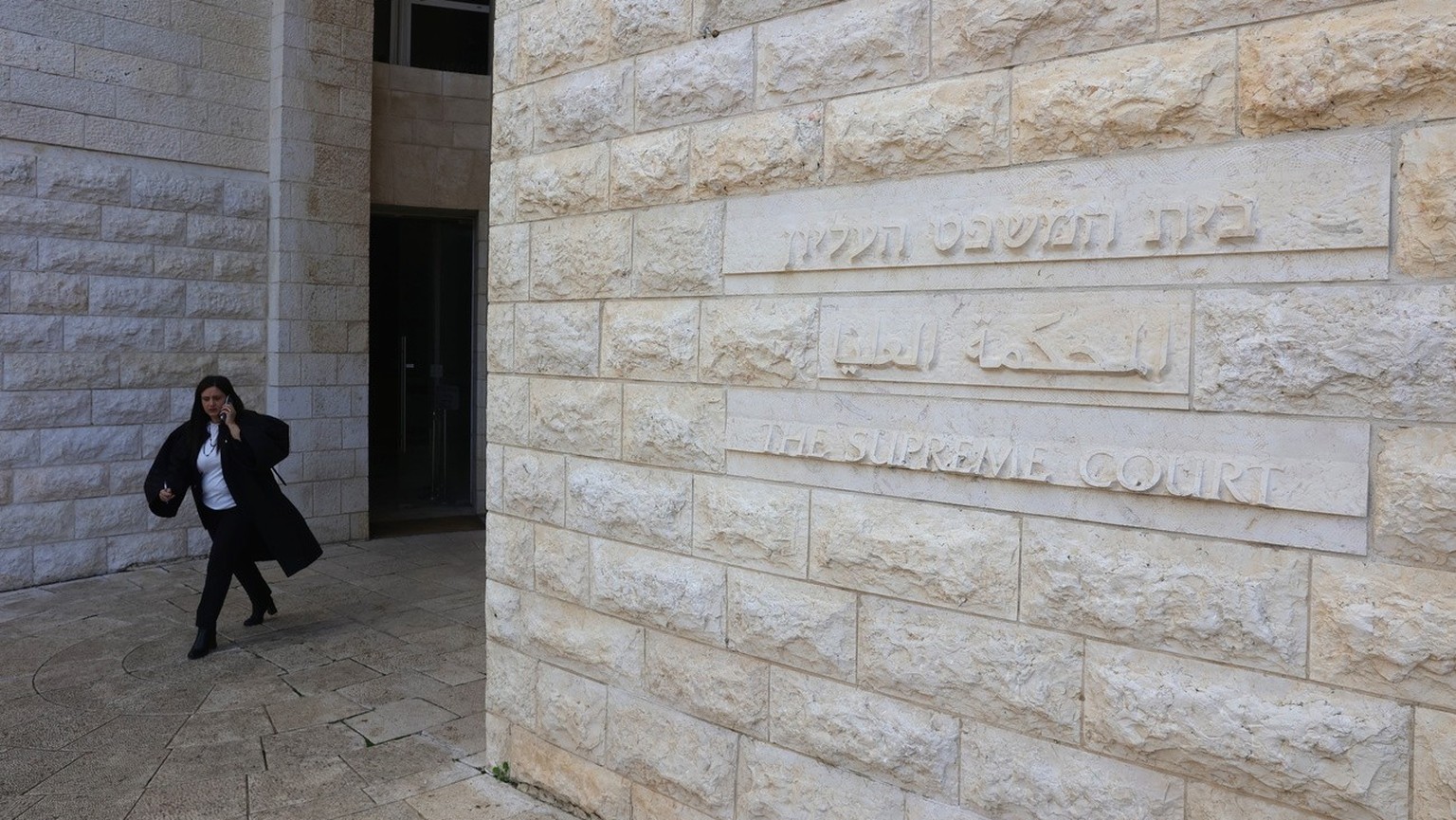 epa11053257 A lawyer leaves the Israeli Supreme Court in Jerusalem, 02 January 2024. As per its statement, Israel&#039;s Supreme Court has on 01 January and by a majority vote, struck down the main le ...