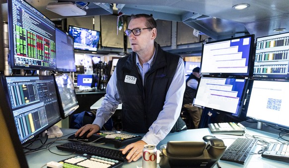 epa09525449 A trader works on the floor of the New York Stock Exchange in New York City, New York, USA, on 15 October 2021. The Dow Jones industrial average was up over 250 points in morning trading a ...