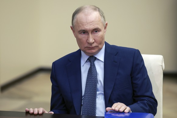Russian President Vladimir Putin listens to Moscow-appointed head of Russian-controlled Zaporizhzhia region of Ukraine Yevgeny Balitsky during their meeting at the Novo-Ogaryovo residence outside Mosc ...