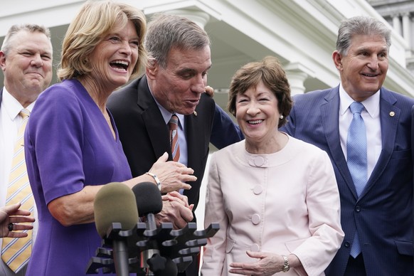 From left, Sen. Jon Tester, D-Mont., Sen. Lisa Murkowski, R-Alaska, Sen. Mark Warner, D-Va., Sen. Susan Collins, R-Maine, and Sen, Joe Manchin, D-W.Va., speak to the media after remarks by President J ...