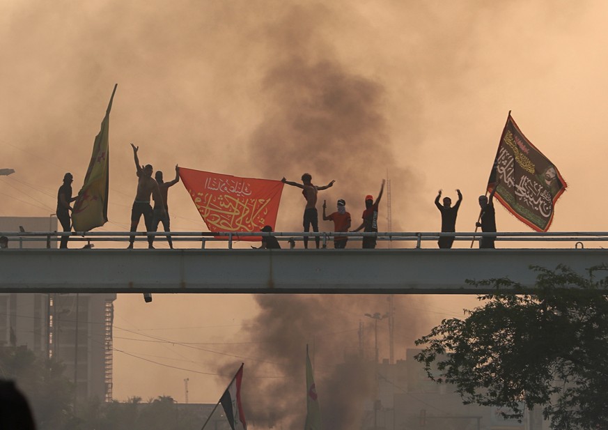 Anti-government protesters chant slogans during a protest in Baghdad, Iraq, Wednesday, Oct. 2, 2019. Iraqi officials said several protesters have been killed Wednesday and scores injured amid gunfire  ...