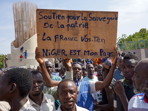 epa10777415 Protesters with a placard ���France go away, Niger is my country��� during a protest in Niamey, Niger, 30 July 2023. Thousands of supporters of General Abdourahamane Tchiani, head of the P ...