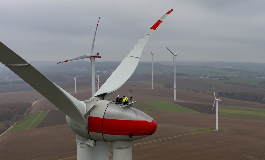Two technicians from Sabowind GmbH maintain an Enercon E92 wind turbine in Bernsdorf, Germany, Monday, Nov. 15, 2021. On the same day, the campaign &quot;Energieland Sachsen. Renew together.&quot; was ...