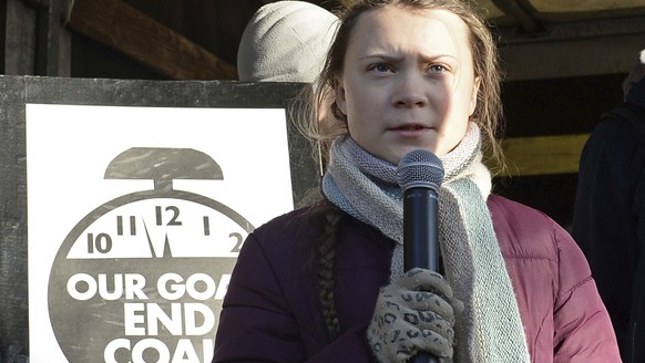 Swedish young activist, 15-year-old Greta Thunberg, right, speaks to climate activists during the March for Climate in a protest against global warming in Katowice, Poland, Saturday, Dec. 8, 2018, as  ...