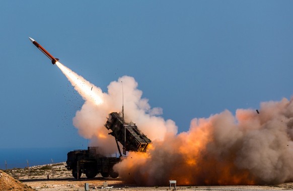 FILE - In this image released by the U.S. Department of Defense, German soldiers assigned to Surface Air and Missile Defense Wing 1, fire the Patriot weapons system at the NATO Missile Firing Installa ...