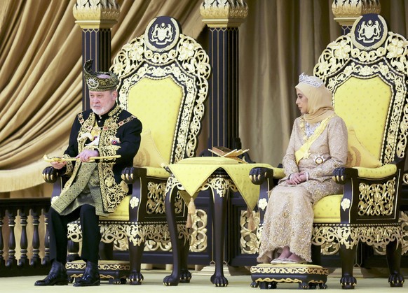 epa11488729 The King of Malaysia, Sultan Ibrahim Iskandar, lifts a ceremonial dagger next to Queen Raja Zarith Sofiah during his coronation ceremony at the National Palace in Kuala Lumpur, Malaysia, 2 ...