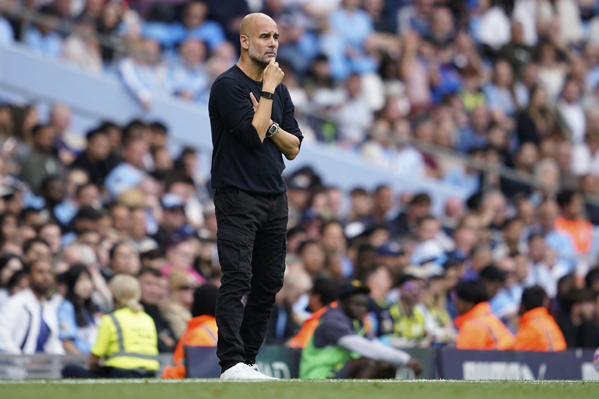 Manchester City's head coach Pep Guardiola watches the game during the Premier League soccer match between Manchester City and Tottenham in Manchester, England, Saturday, Aug. 23, 2025. (AP Photo ...