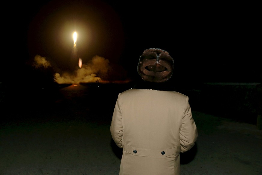 North Korean leader Kim Jong Un watches the ballistic rocket launch drill of the Strategic Force of the Korean People&#039;s Army (KPA) at an unknown location, in this undated photo released by North  ...