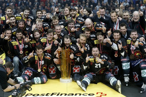 Bern&#039;s players celebrate with the winner&#039;s trophy of the National League A (NLA) Swiss Championship after Bern&#039;s victory over Fribourg Gotteron in the Playoff Final game of National Lea ...