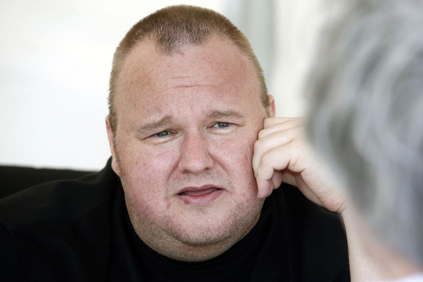 Kim Dotcom talks with supporters at his Internet Party pool party at the Dotcom mansion in Coatesville, Auckland April 13, 2014. Dotcom launched a new political party to contest New Zealand&#039;s gen ...