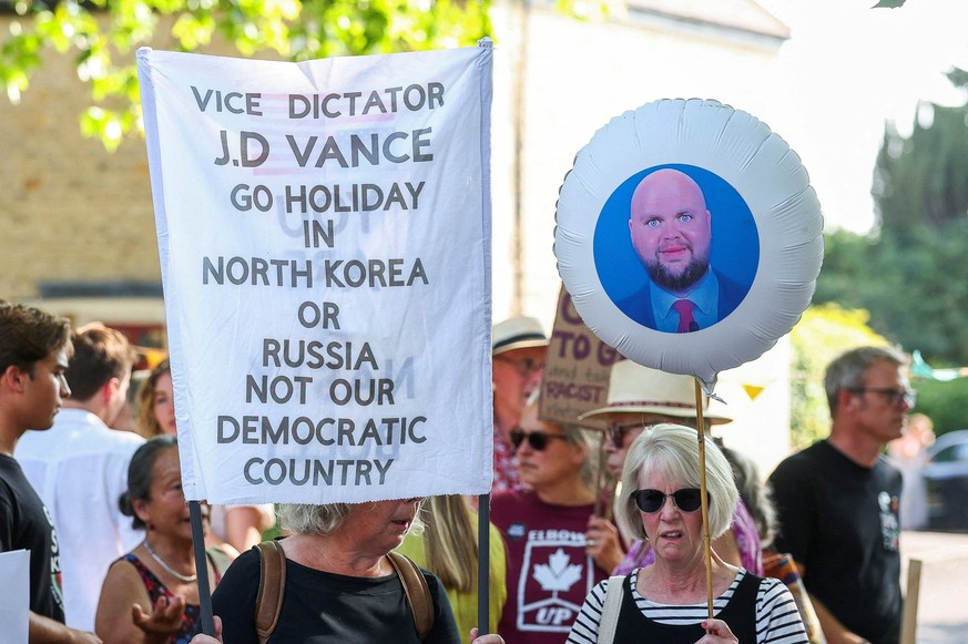 People attend the &quot;Vance not welcome party&quot; protest, organised by Everybody Hates Elon and Stop Trump Coalition, as U.S. Vice President JD Vance spends his holiday nearby, in Charlbury, Cots ...