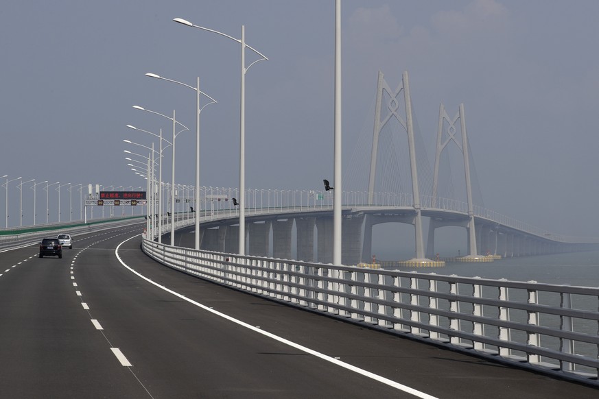Cars drive on the Hong Kong-Zhuhai-Macau Bridge, in Zhuhai city, south China&#039;s Guangdong province, Wednesday, March 28, 2018. The Hong Kong-Zhuhai-Macau Bridge, the world&#039;s longest cross-sea ...