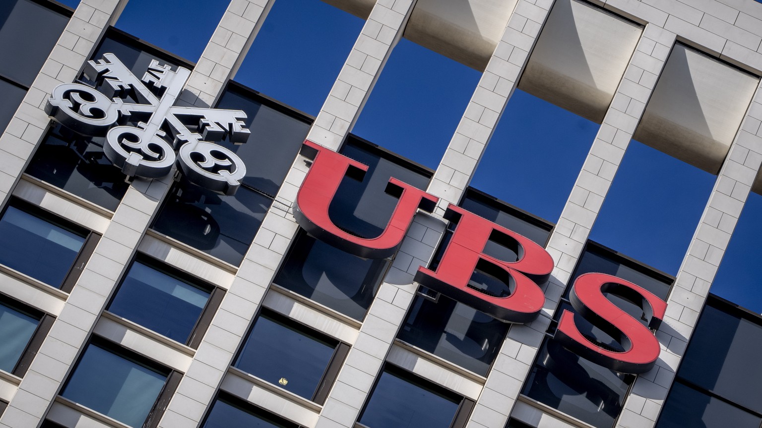 FILE - The logo of Swiss bank UBS is fixed on a building where the bank has offices in Frankfurt, Germany, Nov. 8, 2022. Swiss banking giant UBS will pay nearly $400 million in fines to U.S., Swiss an ...