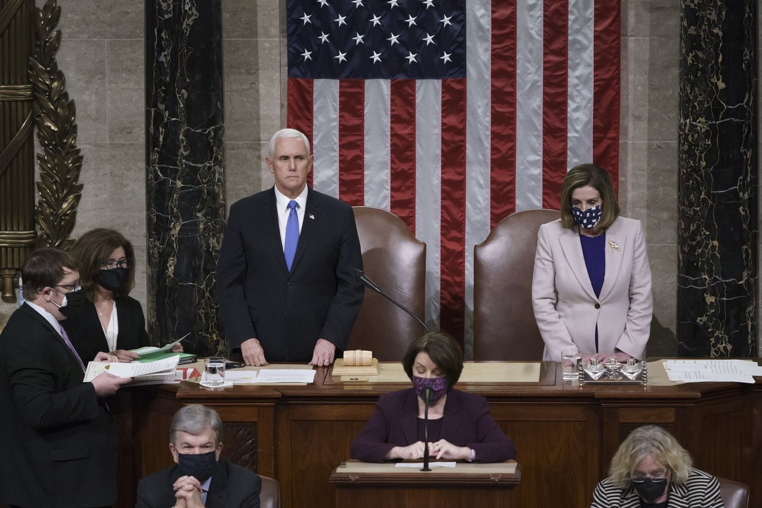 Vice President Mike Pence and Speaker of the House Nancy Pelosi, D-Calif., read the final certification of Electoral College votes cast in November&#039;s presidential election during a joint session  ...