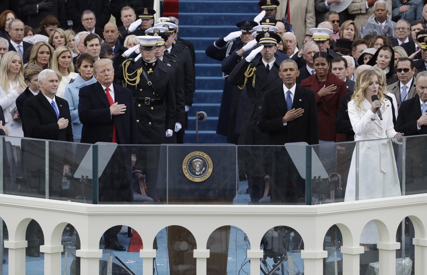 FILE - In this Jan. 20, 2017, file photo President Donald Trump and Vice President Mike Pence listen to the National Anthem sung by Jackie Evancho with former President Barack Obama and his wife Miche ...