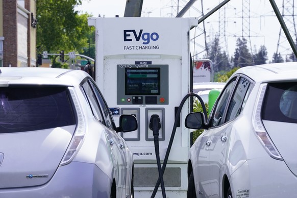 Electric cars are parked at a charging station in Sacramento, Calif., Wednesday, April 13, 2022. California wants electric vehicle sales to triple in the next four years to 35% of all new car purchase ...