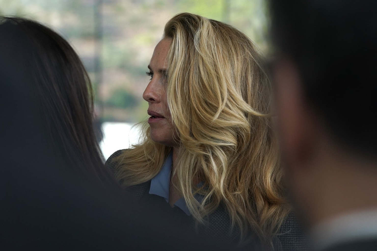 Laurene Powell, the widow of Steve Jobs, waits to enter the Steve Jobs Theater for an event to announce new products Monday, March. 25, 2019, in Cupertino, Calif. (AP Photo/Tony Avelar)