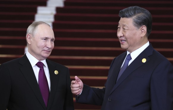 FILE - Russian President Vladimir Putin, left, and Chinese President Xi Jinping talk during their meeting on the sidelines of the Belt and Road Forum in Beijing, China, on Tuesday, Oct. 17, 2023. (Ser ...