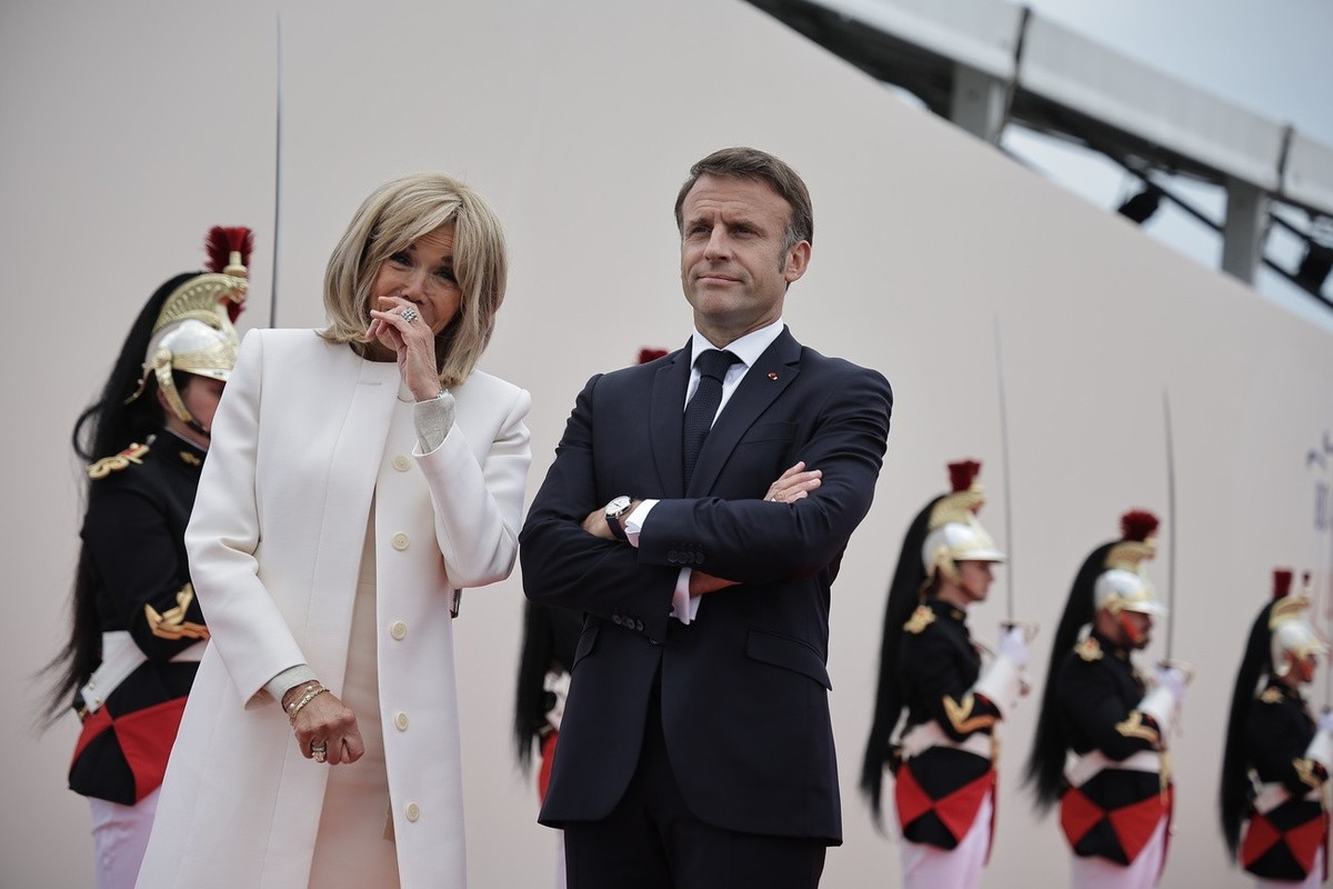 epa11393482 French President Emmanuel Macron (R), his wife Brigitte Macron attend a commemorative ceremony with dozens of heads of States and more than 200 veterans for the 80th anniversary of D-Day l ...