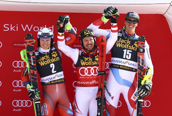 From left, second placed Norway&#039;s Henrik Kristoffersen, first placed Austria&#039;s Marcel Hirscher and third placed Switzerland&#039;s Ramon Zenhaeusern celebrate on the podium of an alpine ski, ...