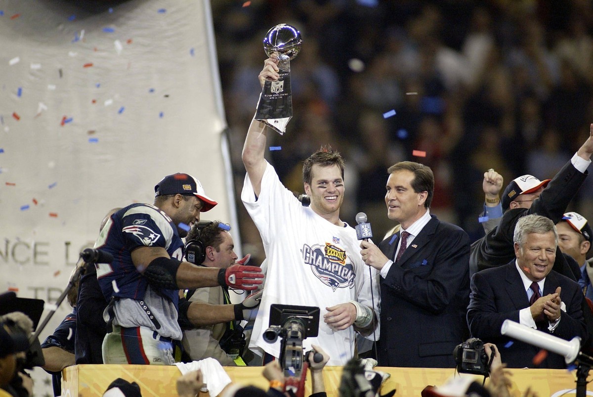 SUPER BOWL XXXVIII Feb 1, 2004 Houston, TX, USA FILE PHOTO New England Patriots quarterback Tom Brady 12 celebrates with the Vince Lombardi Trophy after defeating the Carolina Panthers during Super Bo ...