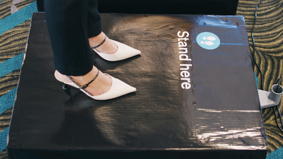 In this photo supplied by Air New Zealand, a woman stands on scales to be weighed ahead of a flight in Auckland, New Zealand on May 29, 2023. New Zealand's national airline is asking people to st ...