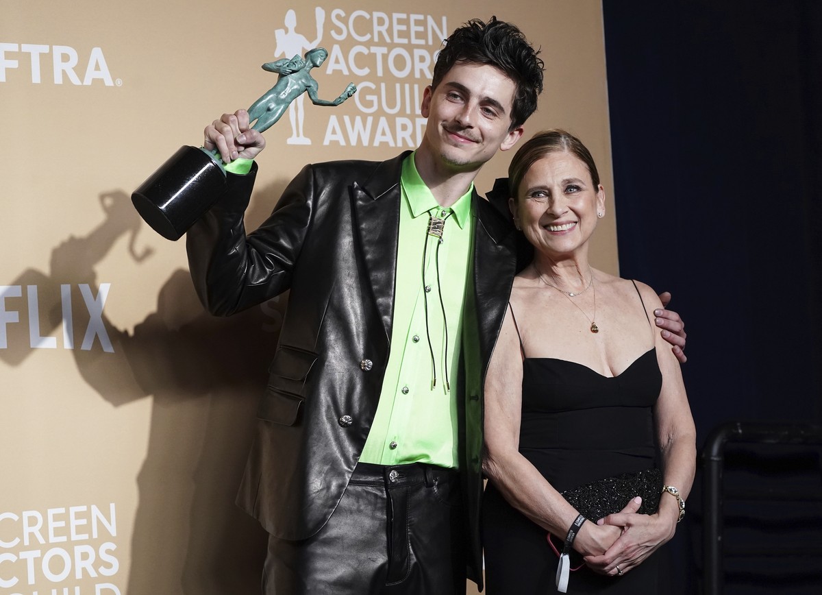 Timothee Chalamet, left, winner of the award for outstanding performance by a male actor in a leading role for "A Complete Unknown," and Nicole Flender pose during the 31st annual Screen Act ...