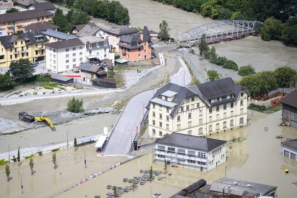 The Rhone River, right, and the Navizence river, left, are overflowing the industrial zone following the storms that caused major flooding, in Chippis, Switzerland, Sunday, June 30, 2024. (KEYSTONE/Je ...