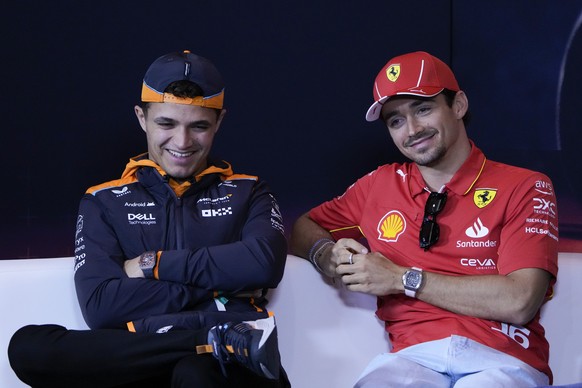 Ferrari driver Charles Leclerc of Monaco, right, and McLaren driver Lando Norris of Britain attend a press conference ahead of the Chinese Formula One Grand Prix at the Shanghai International Circuit  ...